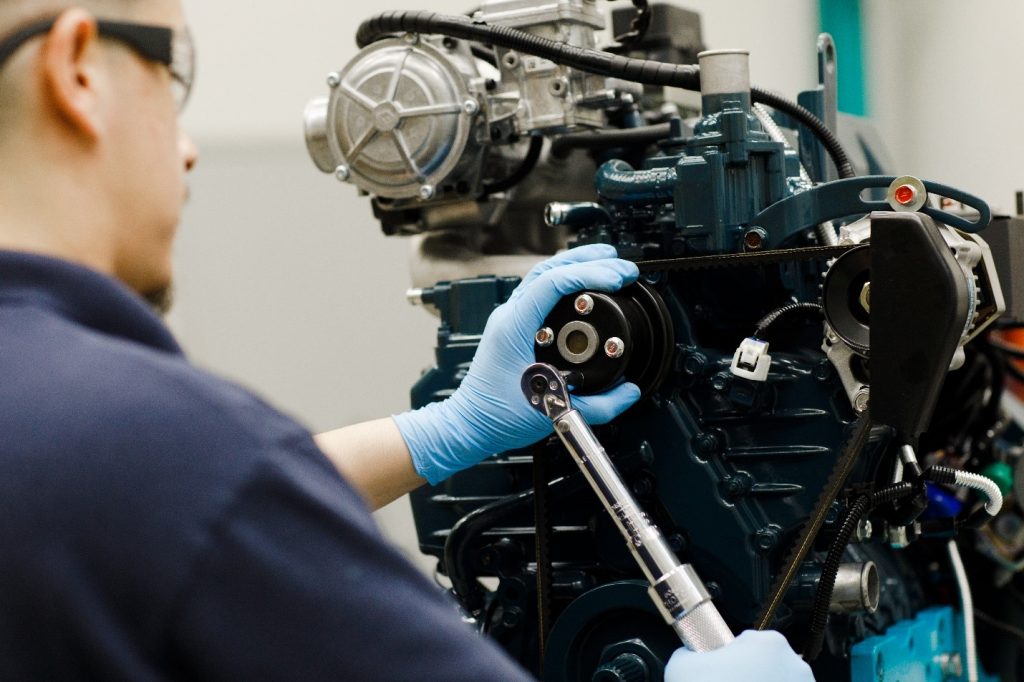 An engine tech works on Kubota engine