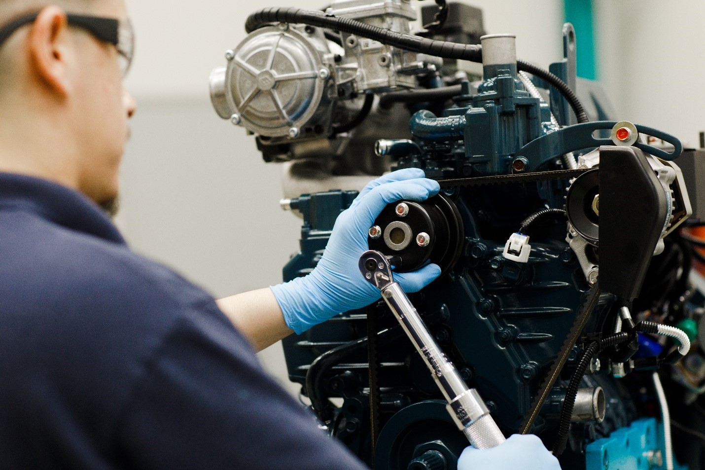 An engine tech works on Kubota engine