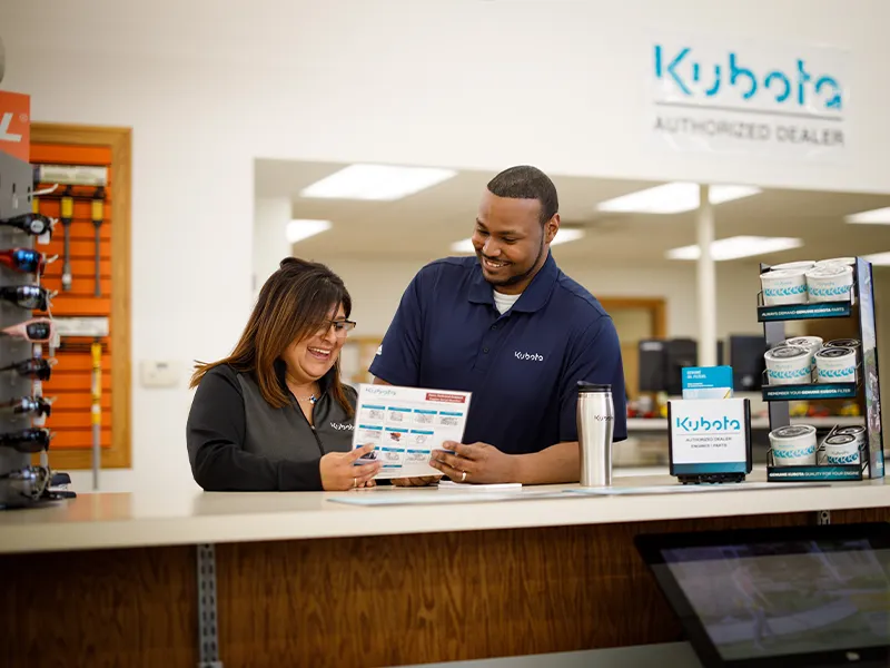 Kubota engine authorized dealer assisting customers with parts and service at a retail counter