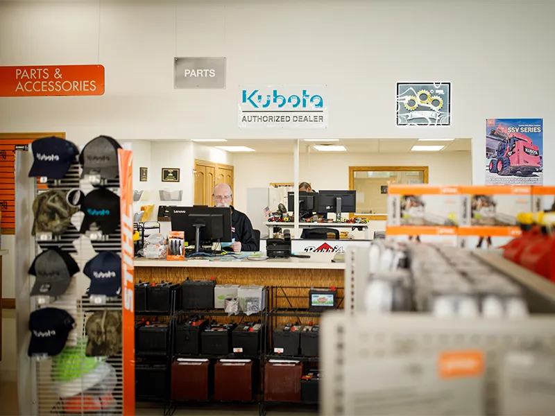 Kubota engine dealership office with employee sitting behind a computer at the front desk.