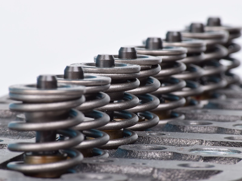 Close-up of Kubota engine cylinder head with valve springs and retainers installed